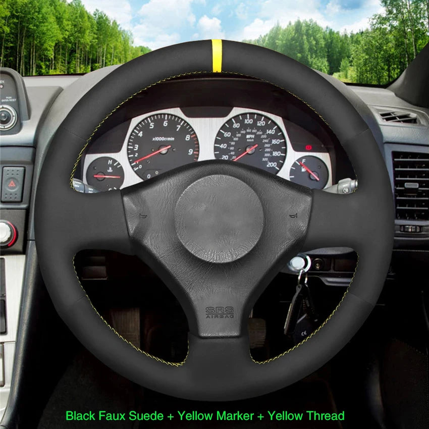 Steering wheel with black faux suede cover, yellow marker, and thread, set against a car interior background.